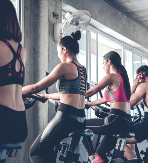 People working out at spinning class in the gym.